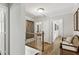 Bright hallway featuring hardwood floors, white trim, and elegant decor with a comfortable wicker bench at 1922 Olde Village Run, Dunwoody, GA 30338