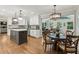 Bright kitchen with an island and stainless appliances open to the eating area and living room at 1922 Olde Village Run, Dunwoody, GA 30338