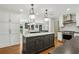 Modern kitchen with large island, stainless steel appliances, and white cabinets at 1922 Olde Village Run, Dunwoody, GA 30338