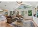 Bright living room with vaulted ceilings, large windows, and a cozy seating area with a decorative rug at 1922 Olde Village Run, Dunwoody, GA 30338