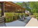 Outdoor patio area with seating and view of screened-in porch with dining and seating at 1922 Olde Village Run, Dunwoody, GA 30338