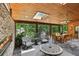 Sunroom with a fireplace, slate flooring, and multiple seating and dining areas at 1922 Olde Village Run, Dunwoody, GA 30338