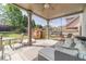 Inviting covered patio with ample seating, ceiling fan, and backyard view that make it ideal for relaxation at 230 Wild Barley Way, Loganville, GA 30052