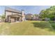 Spacious backyard with green lawn, covered patio, and mature trees that offer a private oasis for relaxation at 230 Wild Barley Way, Loganville, GA 30052