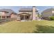 Large backyard with green lawn, covered patio, and well-maintained lawn that's perfect for outdoor activities at 230 Wild Barley Way, Loganville, GA 30052