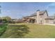 Picturesque view of backyard, featuring expansive lawn, mature trees, and charming details that enhance appeal at 230 Wild Barley Way, Loganville, GA 30052
