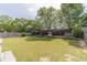 Lush backyard with manicured landscaping, green lawn, and a charming wooden fence creating a private oasis at 230 Wild Barley Way, Loganville, GA 30052