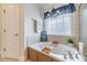 Bathroom featuring a soaking tub, separate glass shower and neutral tile surround at 230 Wild Barley Way, Loganville, GA 30052
