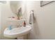 Powder room features pedestal sink and neutral decor at 230 Wild Barley Way, Loganville, GA 30052