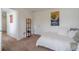 Well-lit bedroom with carpet, complemented by artwork and a modern floor lamp creating a relaxing ambiance at 230 Wild Barley Way, Loganville, GA 30052