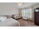 Bright bedroom with neutral décor, large window and carpeted floors creating a cozy atmosphere at 230 Wild Barley Way, Loganville, GA 30052