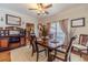 Formal dining room with beautiful decor, set table, and large window for natural light at 230 Wild Barley Way, Loganville, GA 30052