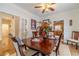 Dining room featuring a set table, hardwood floors, and an open view to the kitchen at 230 Wild Barley Way, Loganville, GA 30052