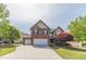 Charming brick and siding home with a well-manicured lawn and a two-car garage at 230 Wild Barley Way, Loganville, GA 30052