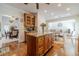 Bright kitchen boasts a large island, hardwood floors, recessed lighting, and stainless appliances at 230 Wild Barley Way, Loganville, GA 30052