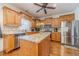 Charming kitchen with stainless appliances, hardwood floors, island, and beautiful wood cabinetry at 230 Wild Barley Way, Loganville, GA 30052