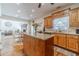 Well-lit kitchen features an island with granite countertops, hardwood floors, and stainless dishwasher at 230 Wild Barley Way, Loganville, GA 30052