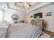 Main bedroom featuring a tray ceiling, decorative mirror, and dresser at 230 Wild Barley Way, Loganville, GA 30052