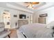 Spacious main bedroom featuring a tray ceiling, ceiling fan, and neutral color palette at 230 Wild Barley Way, Loganville, GA 30052