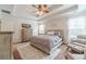 Main bedroom boasting a tray ceiling, large windows, and comfortable seating at 230 Wild Barley Way, Loganville, GA 30052