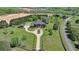 Stunning aerial view showcasing the home's lush landscaping, circular driveway, and expansive green lawn at 5010 Heardmont Trace Rd, Cumming, GA 30028