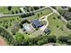 Aerial image highlights the property's vast lot, circular driveway, pool area, and well-maintained grounds at 5010 Heardmont Trace Rd, Cumming, GA 30028