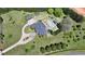 Aerial view of the estate with sprawling lawns, mature trees, a circular driveway, and a backyard pool area at 5010 Heardmont Trace Rd, Cumming, GA 30028
