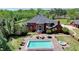 Expansive backyard boasts a large pool, hot tub, brick patio, and lounge seating for relaxation and entertainment at 5010 Heardmont Trace Rd, Cumming, GA 30028