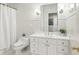 This bathroom has a white vanity with modern fixtures and tile at 5010 Heardmont Trace Rd, Cumming, GA 30028