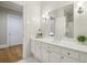 Bright bathroom featuring a white vanity, neutral tile, and modern fixtures at 5010 Heardmont Trace Rd, Cumming, GA 30028