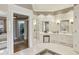 Spacious bathroom featuring white tile flooring, dual sinks, and access to a walk-in closet at 5010 Heardmont Trace Rd, Cumming, GA 30028