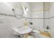 Bright bathroom with decorative wall tiles, pedestal sink, and classic fixtures, offering a clean design at 5010 Heardmont Trace Rd, Cumming, GA 30028