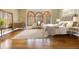 Serene bedroom featuring hardwood floors, arched windows, and neutral tones at 5010 Heardmont Trace Rd, Cumming, GA 30028