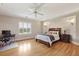 This bedroom features hardwood floors, a ceiling fan, and a desk area perfect for working from home at 5010 Heardmont Trace Rd, Cumming, GA 30028
