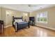 This large bedroom is enhanced by hardwood floors, a decorative ceiling fan, and lots of sunlight at 5010 Heardmont Trace Rd, Cumming, GA 30028
