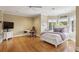 Bedroom featuring hardwood floors, large windows, and a desk area at 5010 Heardmont Trace Rd, Cumming, GA 30028