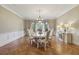 Formal dining room with hardwood floors, large windows, and decorative chandelier at 5010 Heardmont Trace Rd, Cumming, GA 30028