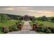 Estate home with a private gate, long driveway, a large front lawn, and beautiful landscaping at 5010 Heardmont Trace Rd, Cumming, GA 30028