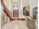 Grand foyer with a curved staircase, tile flooring, and elegant decor at 5010 Heardmont Trace Rd, Cumming, GA 30028