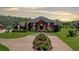 Elegant home features a grand entrance with columns and meticulous landscaping, creating a welcoming curb appeal at 5010 Heardmont Trace Rd, Cumming, GA 30028