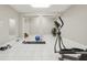 This home gym is equipped with an elliptical machine, free weights, and exercise mat at 5010 Heardmont Trace Rd, Cumming, GA 30028