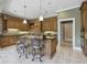 Well-equipped kitchen features a center island with bar seating, tile floors, and modern appliances at 5010 Heardmont Trace Rd, Cumming, GA 30028