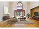 Bright living room with cathedral ceilings, hardwood floors, and large windows at 5010 Heardmont Trace Rd, Cumming, GA 30028