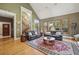 Inviting living room with vaulted ceiling, hardwood floors, and plush seating; leads to staircase and bright windows at 5010 Heardmont Trace Rd, Cumming, GA 30028