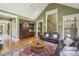 Open living room with built-in cabinets, hardwood floors, and comfortable seating area at 5010 Heardmont Trace Rd, Cumming, GA 30028