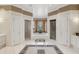 Expansive main bathroom with jacuzzi tub, and vanities, walk-in shower, and decorative tile flooring at 5010 Heardmont Trace Rd, Cumming, GA 30028