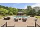 A stunning outdoor pool area with a cabana, lounge seating, dining table, and hot tub perfect for relaxing and entertaining at 5010 Heardmont Trace Rd, Cumming, GA 30028