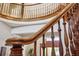 Detail shot of the wooden railing and banister of the curved staircase at 5010 Heardmont Trace Rd, Cumming, GA 30028