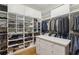 Organized walk-in closet with ample shelving and hanging space, and a center island at 5010 Heardmont Trace Rd, Cumming, GA 30028