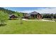 An expansive yard with lush green grass and mature trees surround a luxurious brick home at 5010 Heardmont Trace Rd, Cumming, GA 30028